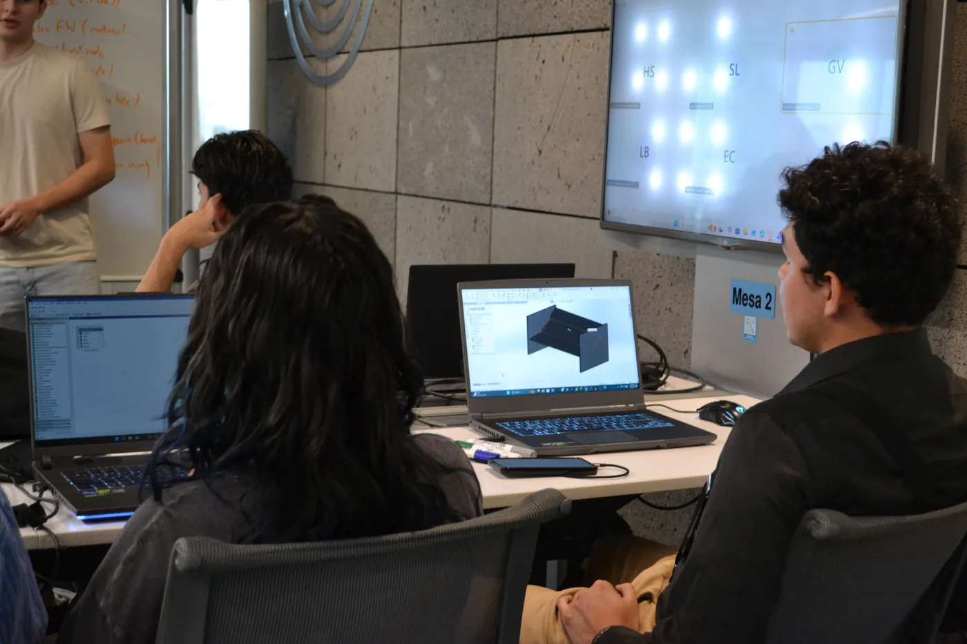 Members working on CAD models during a design session