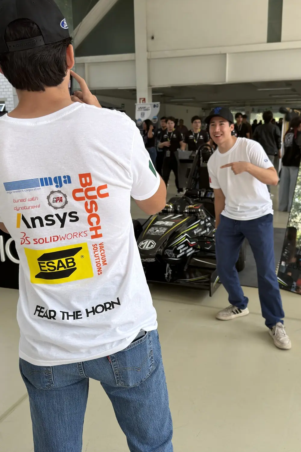 The back of a TEC Racing jersey carrying the partner logotypes, inside the competition hall