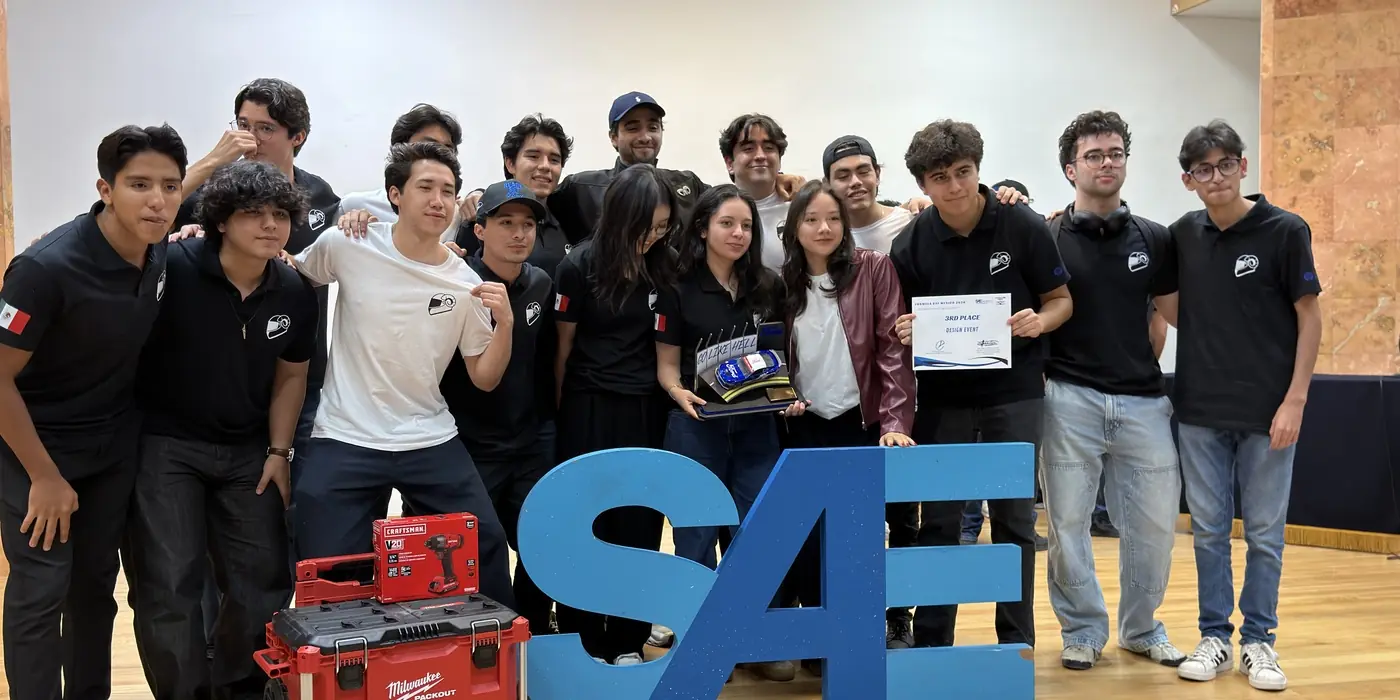The team on stage with the certificate and the awards after the ceremony