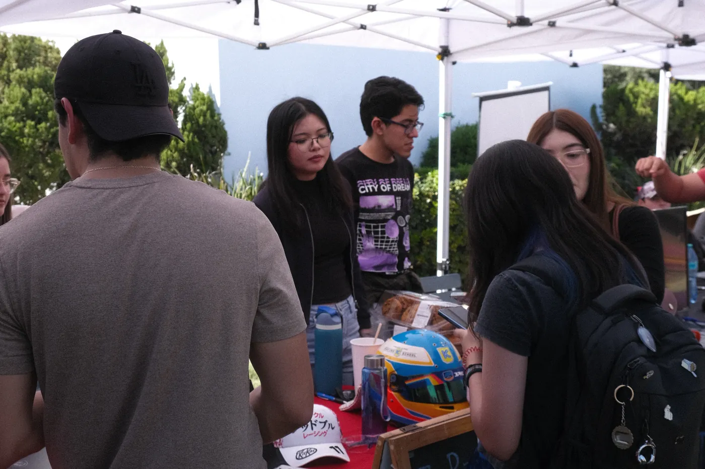 Team stand at a campus outreach event