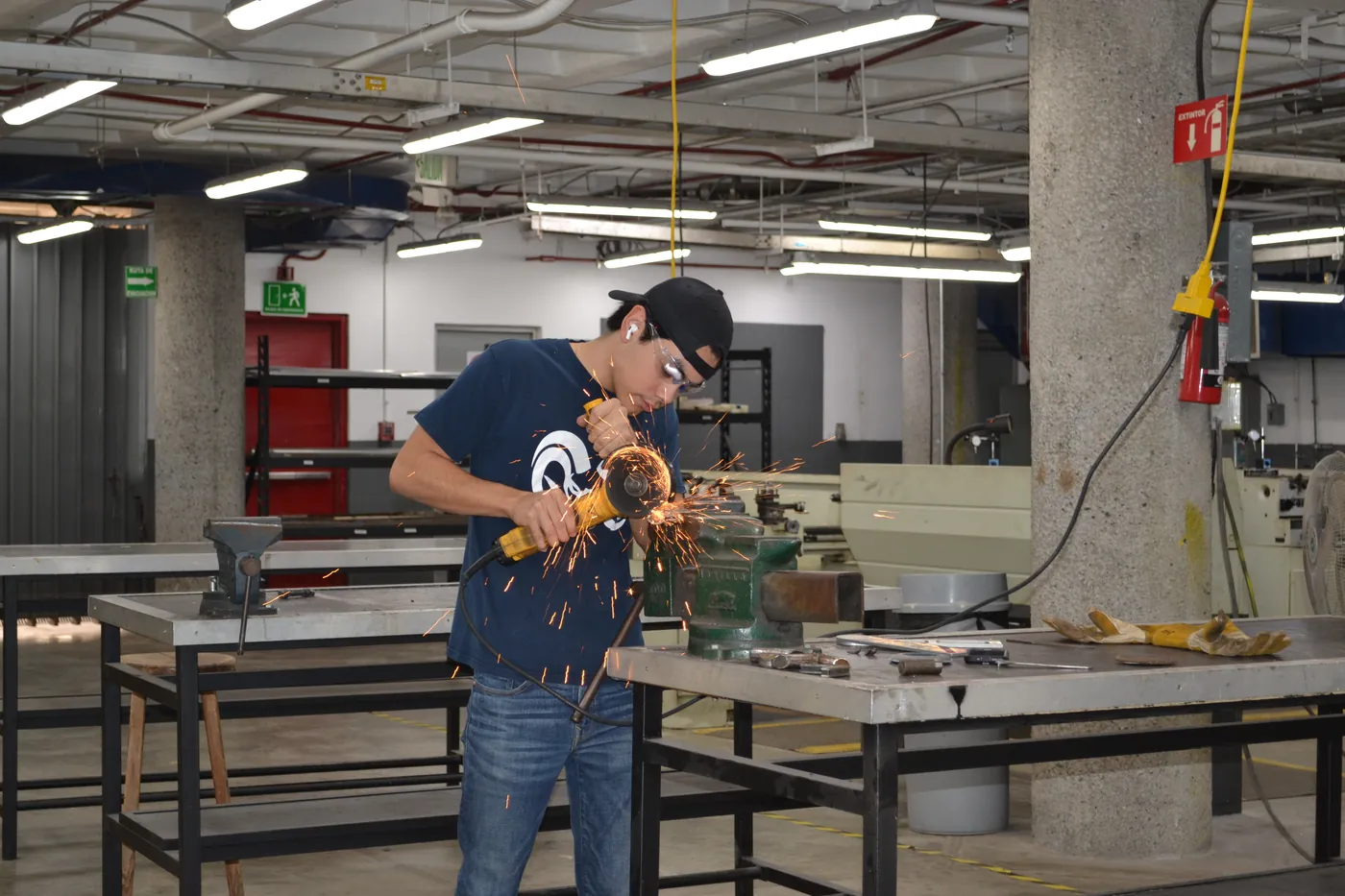 A team member machining a component in the campus workshop